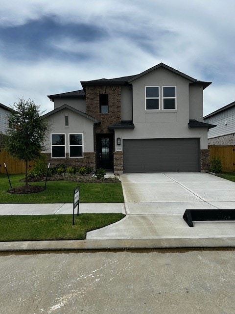 1123 Buffalo Run, Tomball, TX 77375 - view of front of home with an attached garage, concrete driveway, brick siding, and stucco siding
