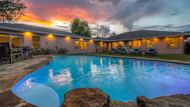 4019 Grennoch Ln, Houston, TX 77025 - pool at dusk featuring an outdoor pool and a patio