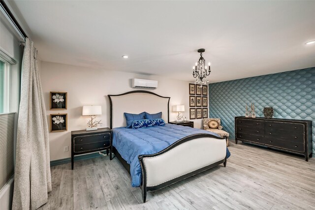 4019 Grennoch Ln, Houston, TX 77025 - bedroom with wallpapered walls, an accent wall, an AC wall unit, a chandelier, and wood finished floors
