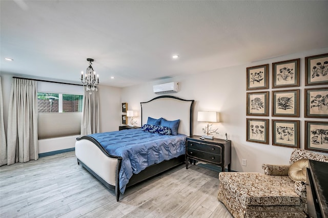4019 Grennoch Ln, Houston, TX 77025 - bedroom with a wall mounted AC, light wood-style flooring, a chandelier, and recessed lighting