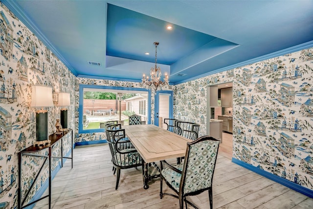 4019 Grennoch Ln, Houston, TX 77025 - dining space with wallpapered walls, a tray ceiling, a chandelier, wood finished floors, and ornamental molding