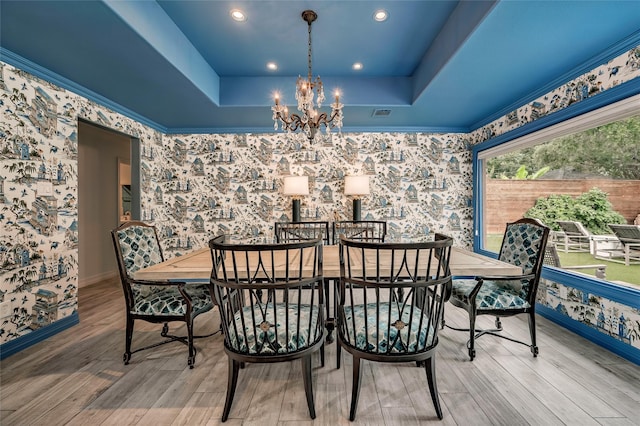 4019 Grennoch Ln, Houston, TX 77025 - dining area with wallpapered walls, a raised ceiling, a chandelier, wood finished floors, and recessed lighting