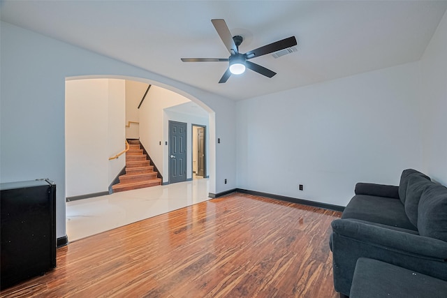 13703 Broad Oaks Ln, Rosharon, TX 77583 - living room featuring stairway, wood finished floors, ceiling fan, and arched walkways