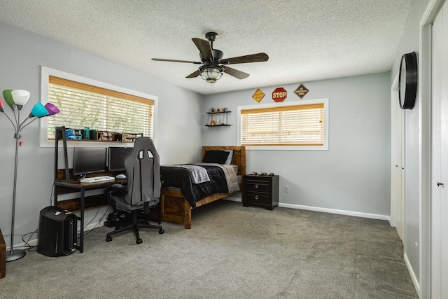 105 Pleasant Valley Dr, West Columbia, TX 77486 - carpeted bedroom with multiple windows, a textured ceiling, and a ceiling fan