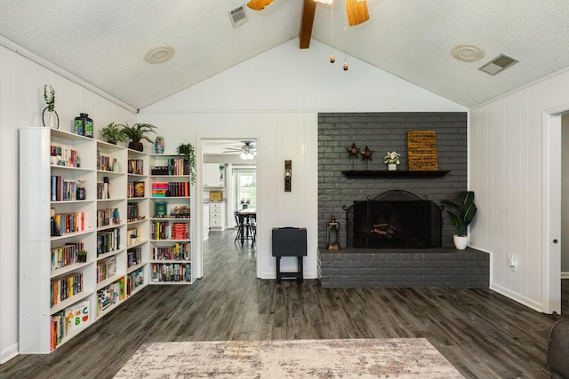 105 Pleasant Valley Dr, West Columbia, TX 77486 - living area with ceiling fan, a fireplace, wood finished floors, and a textured ceiling