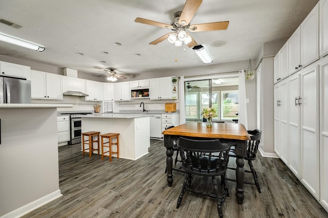 105 Pleasant Valley Dr, West Columbia, TX 77486 - dining room with dark wood-style flooring and ceiling fan