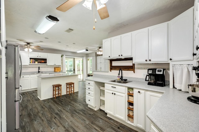 105 Pleasant Valley Dr, West Columbia, TX 77486 - kitchen with a ceiling fan, freestanding refrigerator, open shelves, and white cabinetry