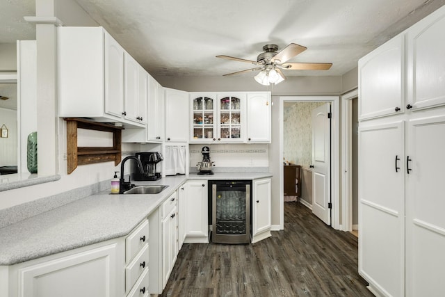 105 Pleasant Valley Dr, West Columbia, TX 77486 - kitchen with beverage cooler, white cabinetry, ceiling fan, and dark wood-style flooring