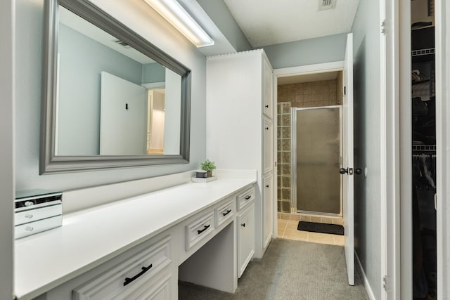 105 Pleasant Valley Dr, West Columbia, TX 77486 - full bathroom featuring a walk in closet, vanity, a shower stall, and tile patterned floors