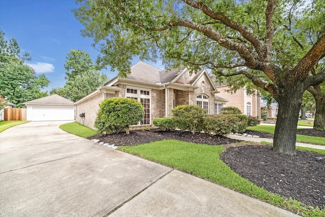 7110 Timber Post Ln, Humble, TX 77346 - view of front facade with brick siding, a detached garage, a shingled roof, and a front yard