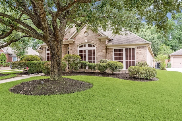 7110 Timber Post Ln, Humble, TX 77346 - view of front of house with a front lawn, brick siding, and a shingled roof