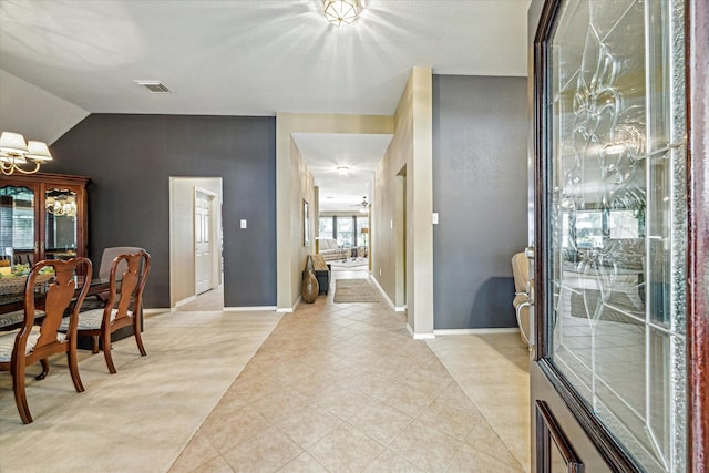 7110 Timber Post Ln, Humble, TX 77346 - foyer entrance featuring vaulted ceiling, light tile patterned flooring, and a chandelier