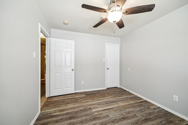 7110 Timber Post Ln, Humble, TX 77346 - unfurnished bedroom featuring dark wood-style floors and ceiling fan