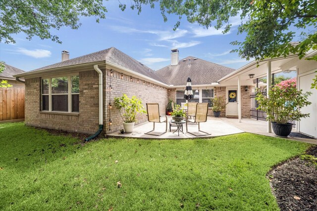 7110 Timber Post Ln, Humble, TX 77346 - rear view of property featuring a chimney, brick siding, a patio, and a shingled roof
