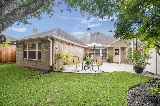 7110 Timber Post Ln, Humble, TX 77346 - rear view of house featuring a chimney, brick siding, and a patio