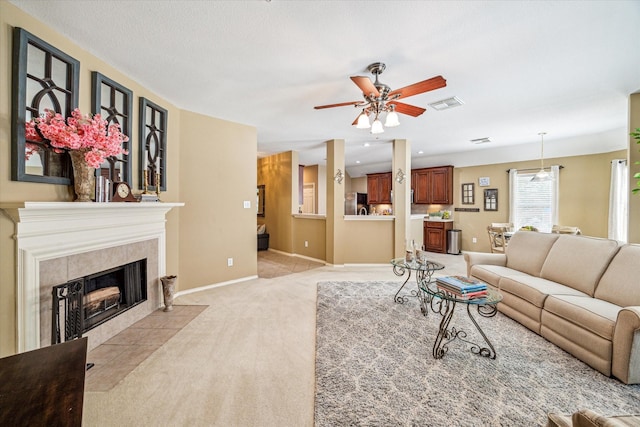 7110 Timber Post Ln, Humble, TX 77346 - living area with light carpet, ceiling fan, and a tiled fireplace