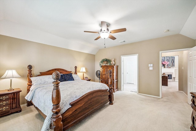 7110 Timber Post Ln, Humble, TX 77346 - bedroom featuring vaulted ceiling, light carpet, a fireplace, and ceiling fan