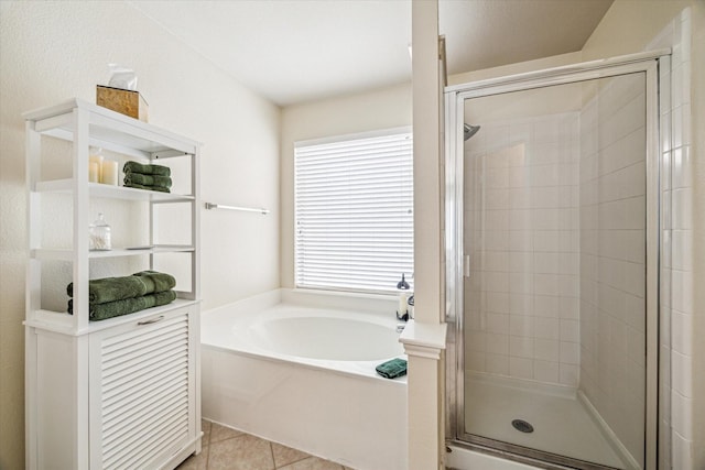 7110 Timber Post Ln, Humble, TX 77346 - bathroom with a stall shower, a bath, and tile patterned floors