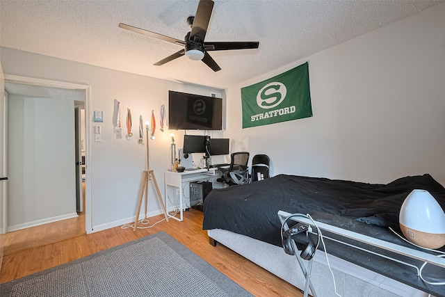 700 Thicket Ln Unit 306, Houston, TX 77079 - bedroom featuring wood finished floors, a textured ceiling, and ceiling fan