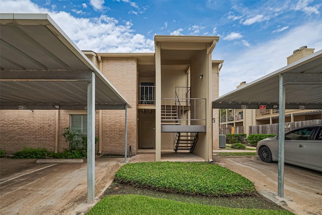 700 Thicket Ln Unit 306, Houston, TX 77079 - view of front facade with stairway, brick siding, and covered parking
