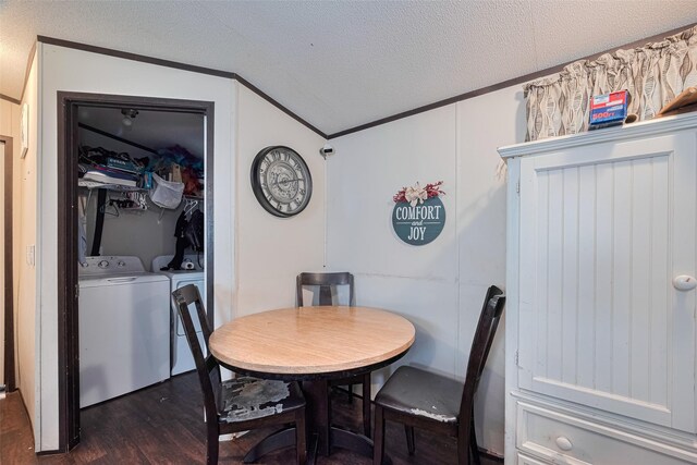 232 3rd St, Dickinson, TX 77539 - dining space featuring washing machine and dryer, ornamental molding, dark wood-style floors, and a textured ceiling