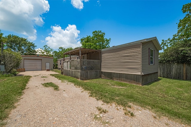 232 3rd St, Dickinson, TX 77539 - view of side of home with dirt driveway, an outbuilding, and a detached garage