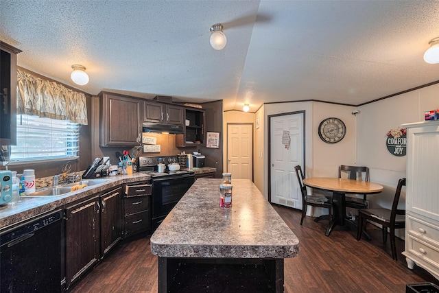 232 3rd St, Dickinson, TX 77539 - kitchen featuring black appliances, dark wood-style flooring, under cabinet range hood, a textured ceiling, and a kitchen island