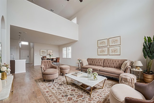 10023 Rose Mallow Ln, Magnolia, TX 77354 - living room with arched walkways, a towering ceiling, and ceiling fan