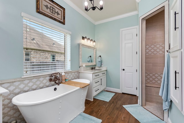32226 Waterford Crest Ln, Fulshear, TX 77441 - full bathroom with a freestanding tub, vanity, ornamental molding, wood finished floors, and a chandelier