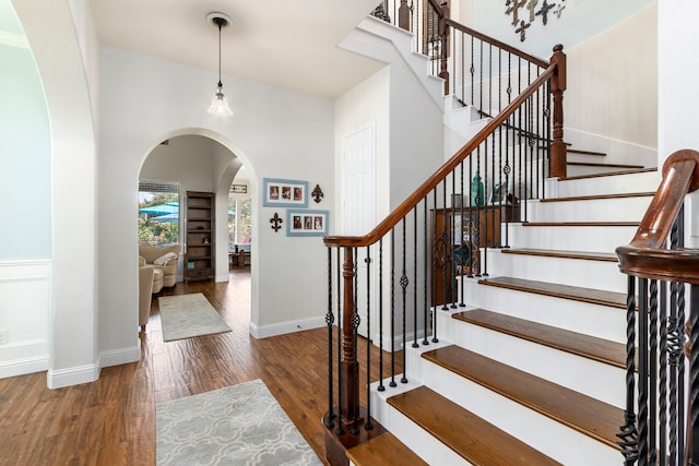 32226 Waterford Crest Ln, Fulshear, TX 77441 - entrance foyer with arched walkways, wood finished floors, and stairs