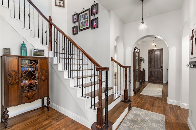 32226 Waterford Crest Ln, Fulshear, TX 77441 - foyer entrance featuring wood finished floors, arched walkways, and stairway