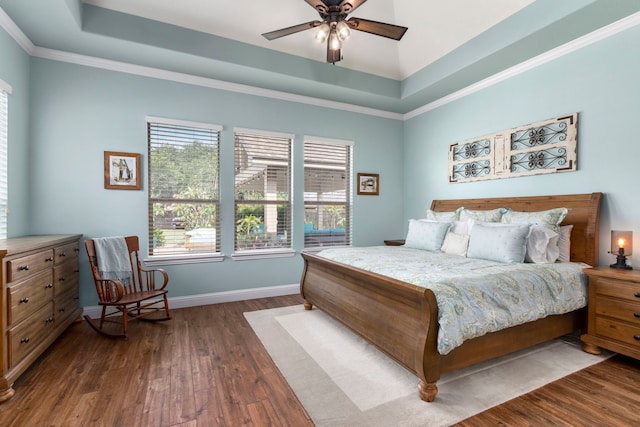 32226 Waterford Crest Ln, Fulshear, TX 77441 - bedroom with multiple windows, dark wood finished floors, a tray ceiling, and ornamental molding