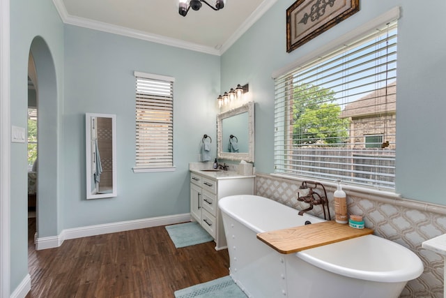 32226 Waterford Crest Ln, Fulshear, TX 77441 - bathroom featuring a freestanding bath, vanity, wood finished floors, and ornamental molding