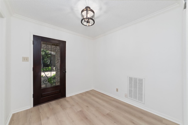 18307 Cransley Dr, Houston, TX 77084 - entrance foyer featuring light wood-type flooring, crown molding, and a textured ceiling