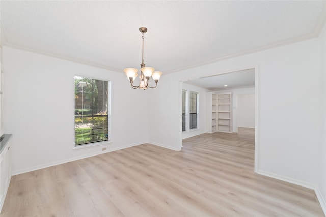 18307 Cransley Dr, Houston, TX 77084 - unfurnished dining area featuring a chandelier, light wood-type flooring, crown molding, and built in features