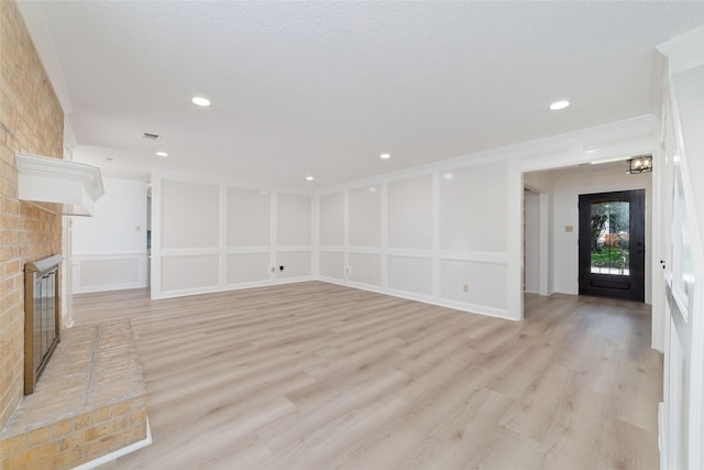 18307 Cransley Dr, Houston, TX 77084 - unfurnished living room with a fireplace, light wood-style floors, and recessed lighting