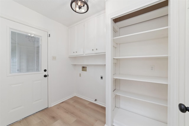 18307 Cransley Dr, Houston, TX 77084 - washroom featuring hookup for an electric dryer, hookup for a washing machine, light wood-style floors, and cabinet space