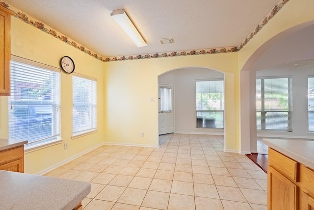 7907 Swan Hollow Ct, Houston, TX 77041 - unfurnished dining area with light tile patterned flooring and plenty of natural light
