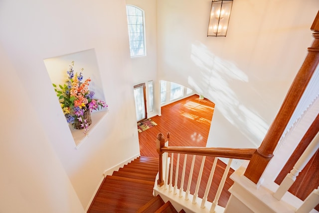 7907 Swan Hollow Ct, Houston, TX 77041 - staircase with a towering ceiling and wood finished floors
