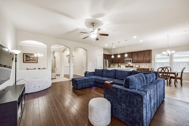 2012 Post Oak Ct, Pearland, TX 77581 - living area featuring a chandelier, arched walkways, ceiling fan, dark wood finished floors, and recessed lighting