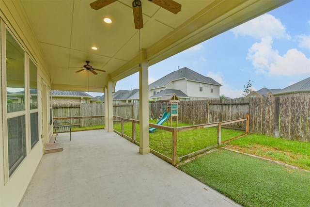 2012 Post Oak Ct, Pearland, TX 77581 - fenced backyard with ceiling fan, a patio, and a playground