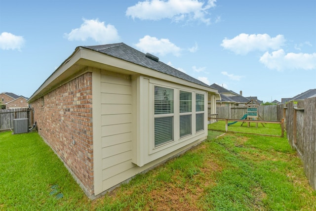 2012 Post Oak Ct, Pearland, TX 77581 - view of property exterior featuring a playground, brick siding, a fenced backyard, and roof with shingles