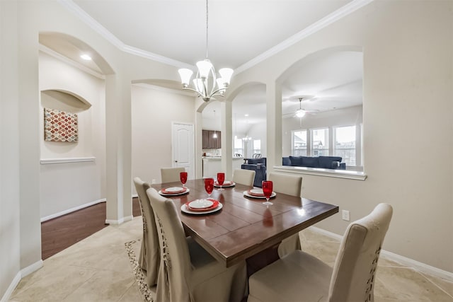 2012 Post Oak Ct, Pearland, TX 77581 - dining area with arched walkways, crown molding, ceiling fan, a chandelier, and light tile patterned flooring