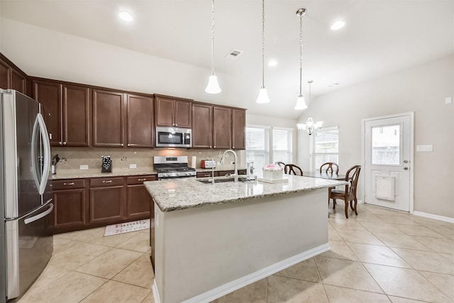 2012 Post Oak Ct, Pearland, TX 77581 - kitchen featuring stainless steel appliances, light tile patterned floors, decorative backsplash, a chandelier, and hanging light fixtures