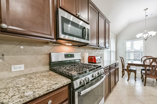 2012 Post Oak Ct, Pearland, TX 77581 - kitchen featuring appliances with stainless steel finishes, backsplash, a chandelier, lofted ceiling, and light stone counters