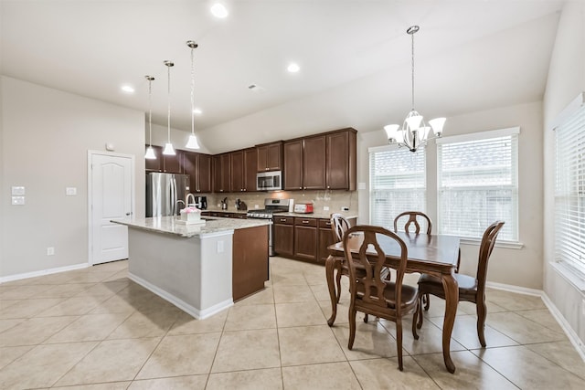 2012 Post Oak Ct, Pearland, TX 77581 - kitchen with appliances with stainless steel finishes, a chandelier, decorative backsplash, lofted ceiling, and a center island with sink