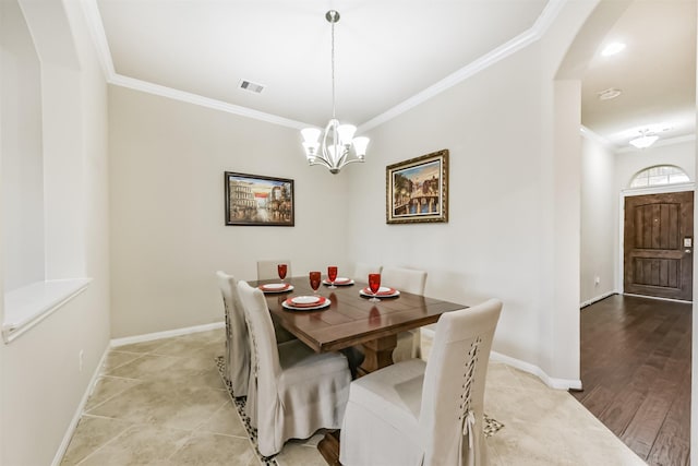 2012 Post Oak Ct, Pearland, TX 77581 - dining room featuring crown molding, a chandelier, and arched walkways