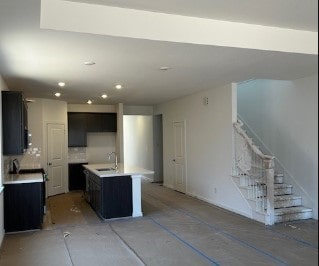 1219 Buffalo Run, Tomball, TX 77375 - kitchen with decorative backsplash, light countertops, an island with sink, recessed lighting, and open floor plan