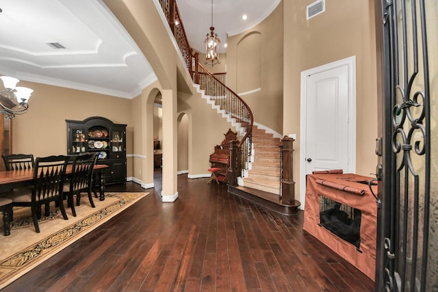 102 Stonecrop Pl, Montgomery, TX 77316 - foyer entrance with arched walkways, a chandelier, hardwood / wood-style floors, stairway, and ornamental molding