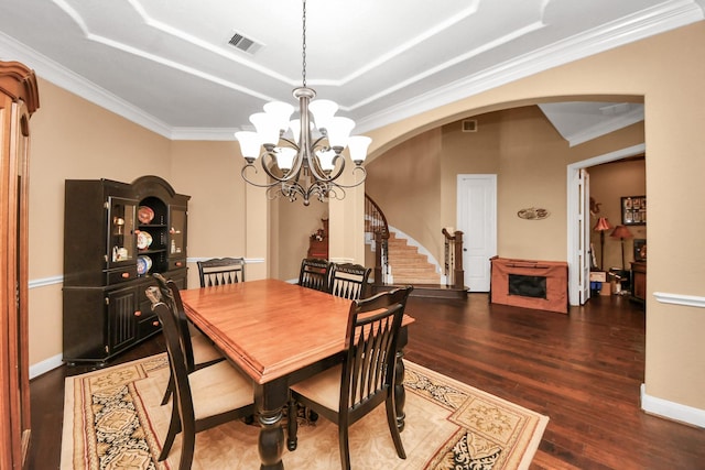 102 Stonecrop Pl, Montgomery, TX 77316 - dining area with arched walkways, crown molding, wood finished floors, stairs, and a raised ceiling